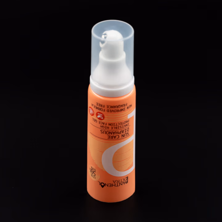 Orange airless tube with metal applicator tip and clear cap