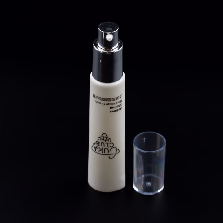 White airless pump tube with silver pump and clear cap, cap off